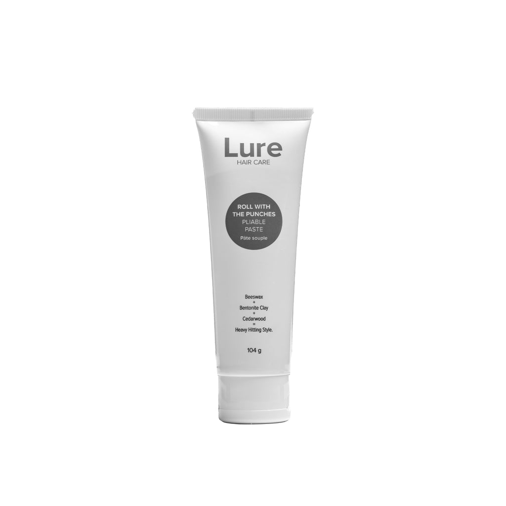 White tube with grey font and logo containing Lure hair care's Roll With The Punches Pliable Paste.