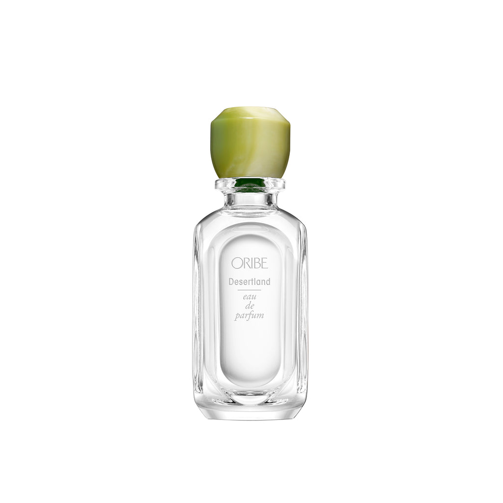 Elongated glass oval shaped bottle with a sculptural, one-of-a-kind resin cap (marbled green and white) whose colour echoes the scent within.