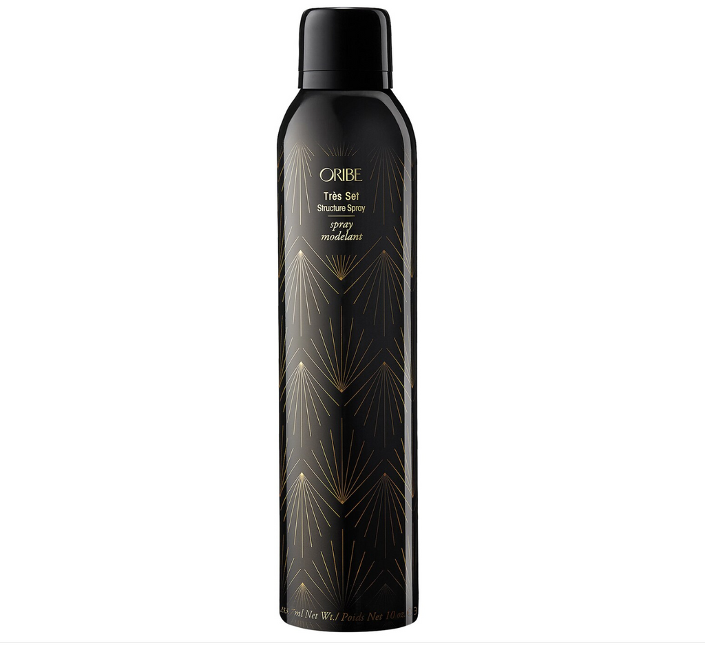 Black aluminum bottle with gold writing and pattern.
